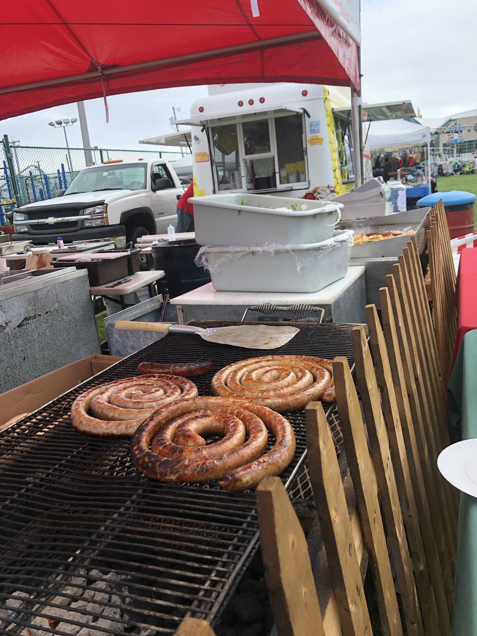A bunch of sausages are cooking on a grill.