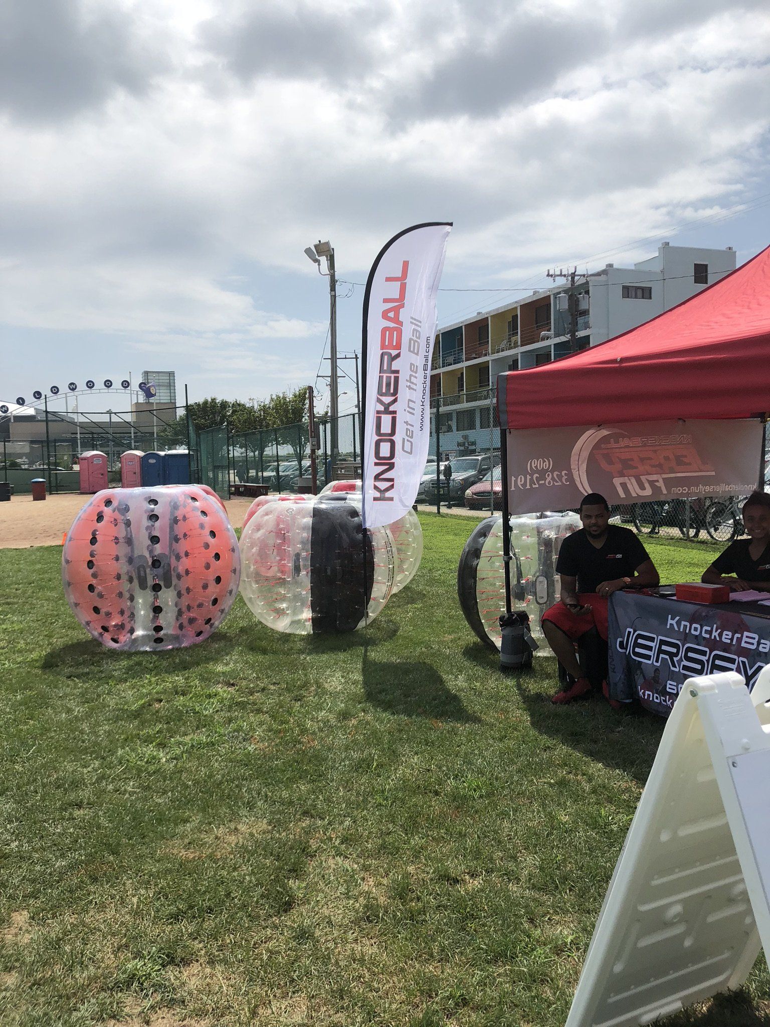 A group of bubble balls are sitting on top of a lush green field.