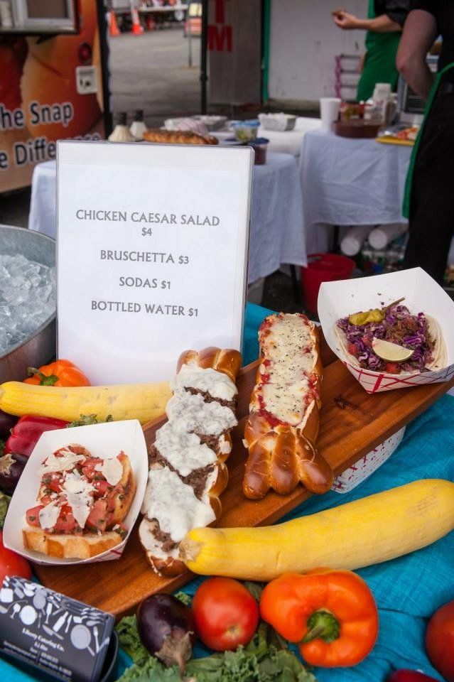 A display of food with a sign that says chicken caesar salad