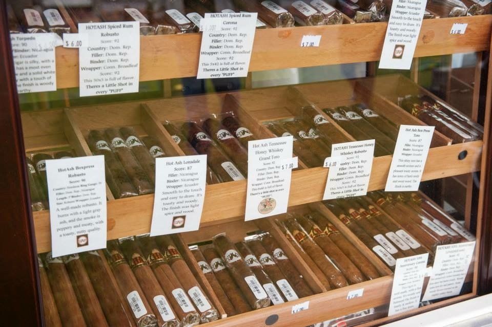 A display case filled with many different types of cigars