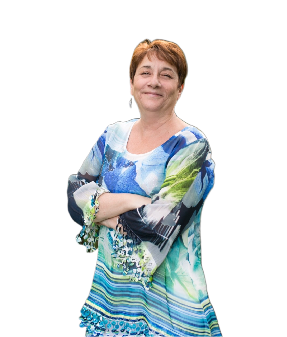 A woman in a blue and green dress is standing with her arms crossed.