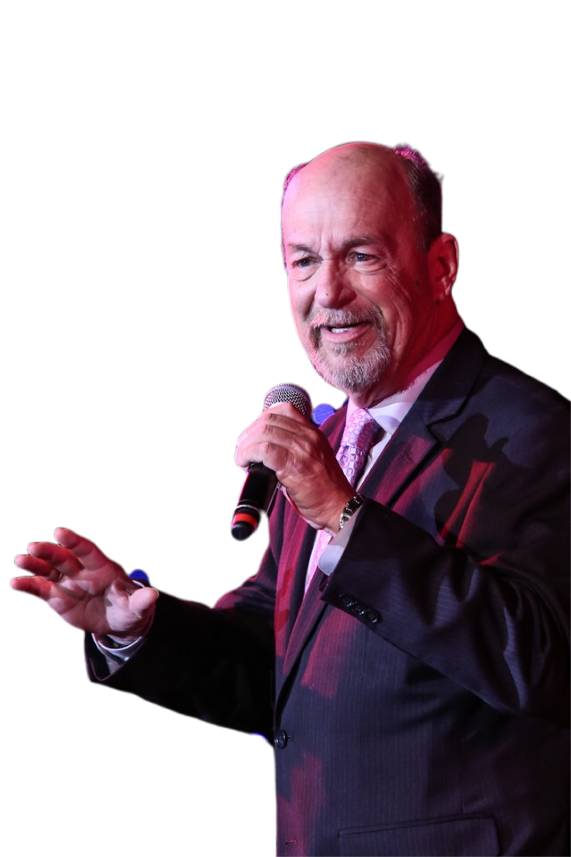 A man in a suit and tie is holding a microphone.