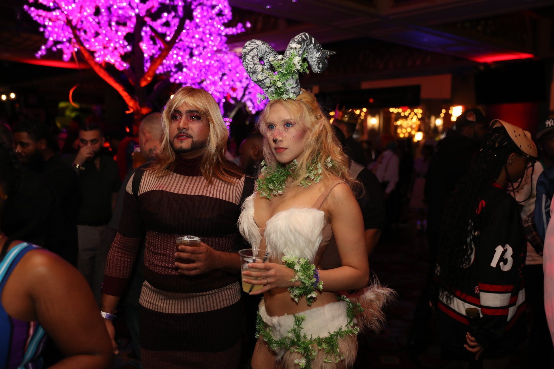A man and a woman are standing next to each other at a party.