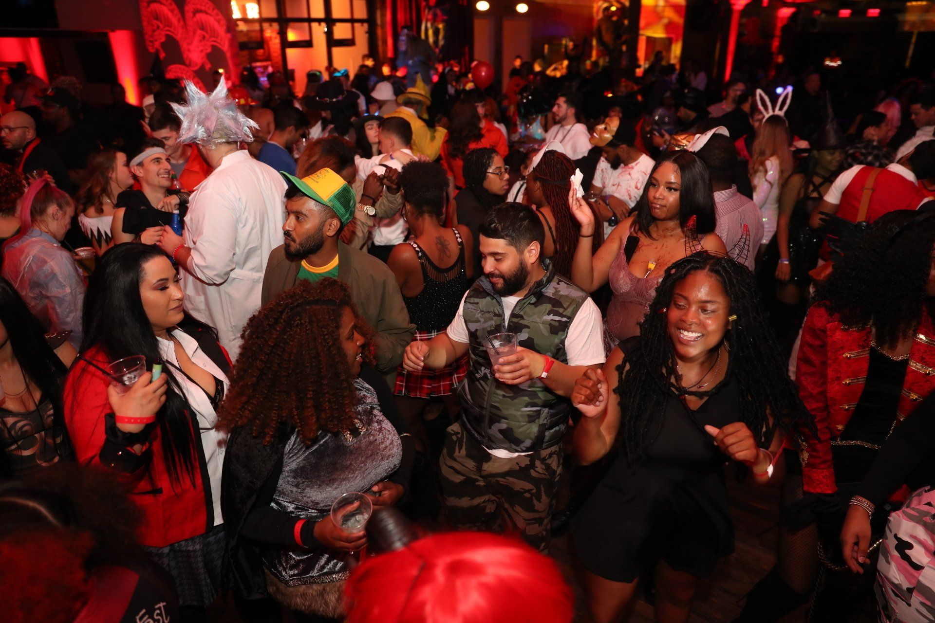 A large group of people are dancing at a party.