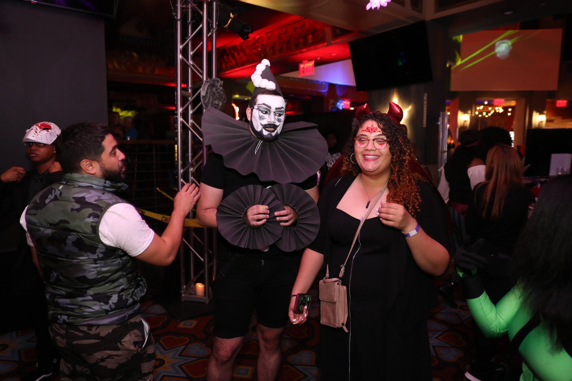 A group of people dressed in costumes are standing in a room.