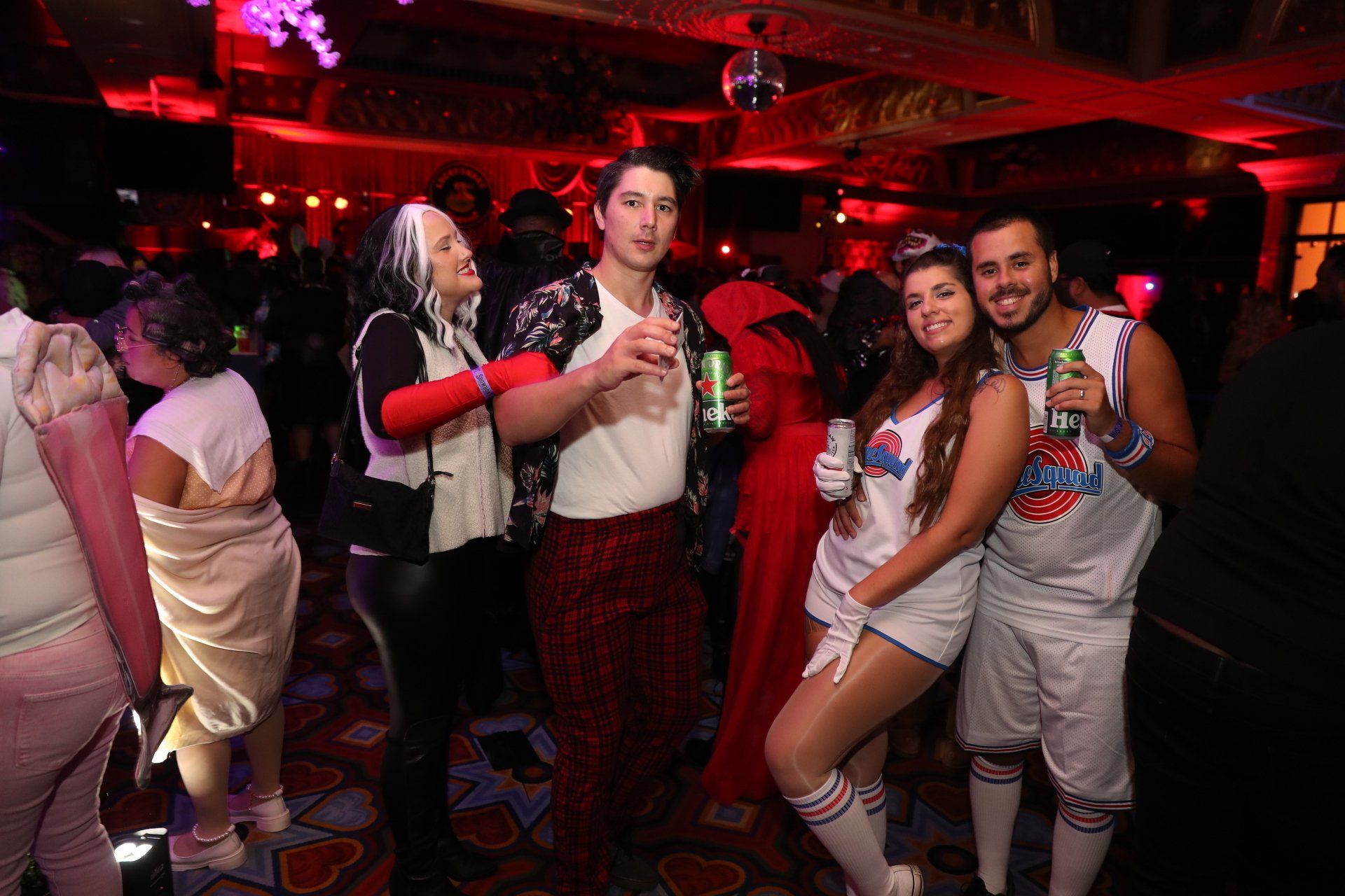 A group of people are posing for a picture at a halloween party.