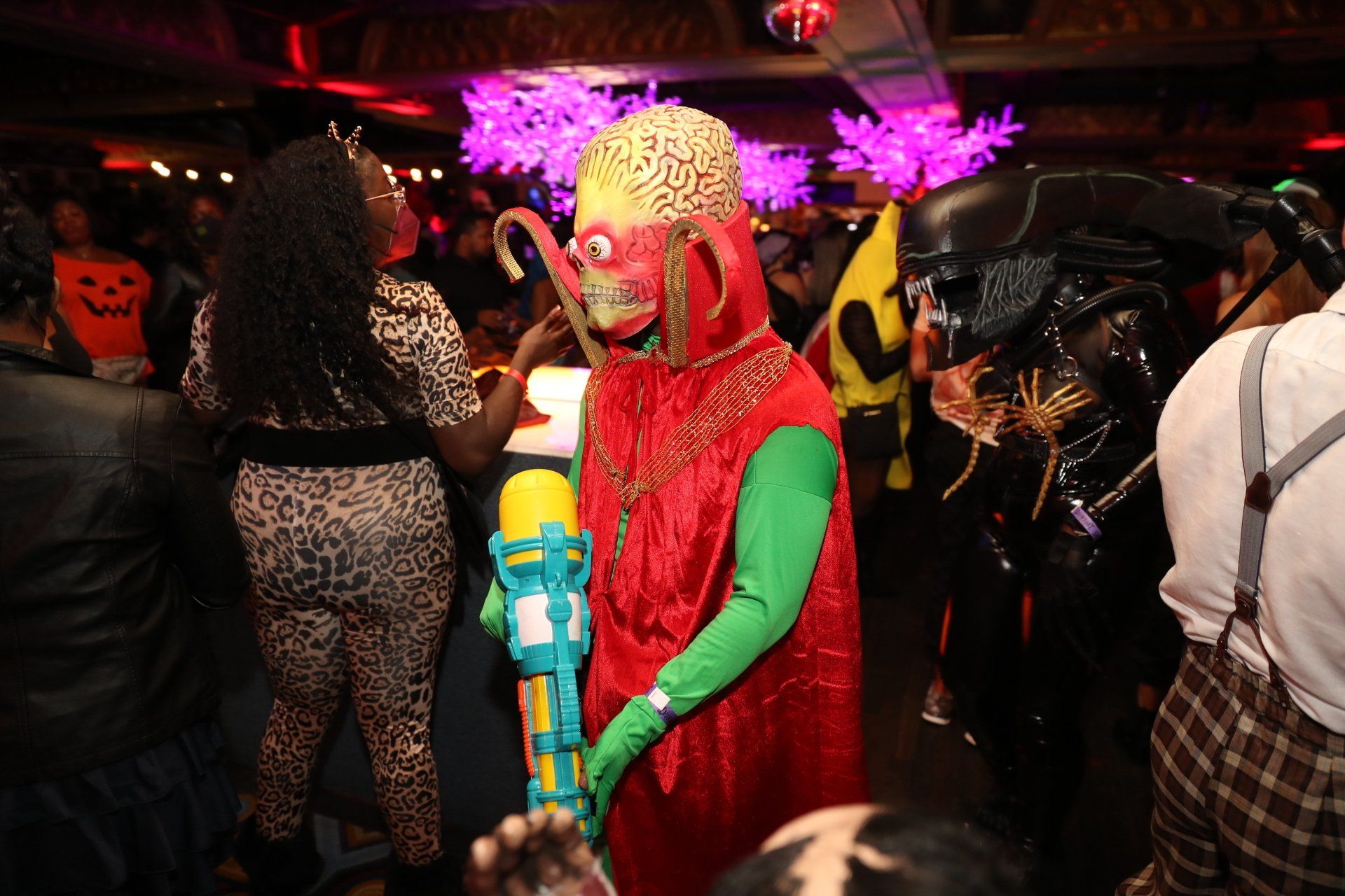 A group of people dressed in costumes are standing in a room.