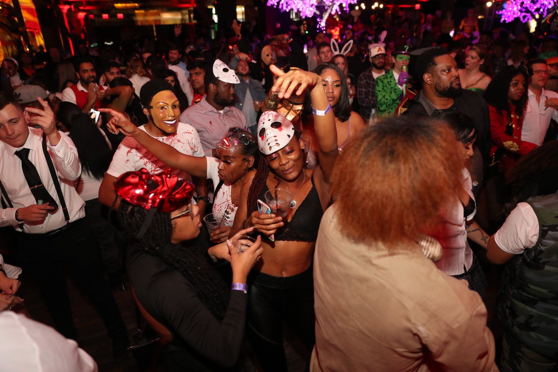 A large group of people are dancing at a party.