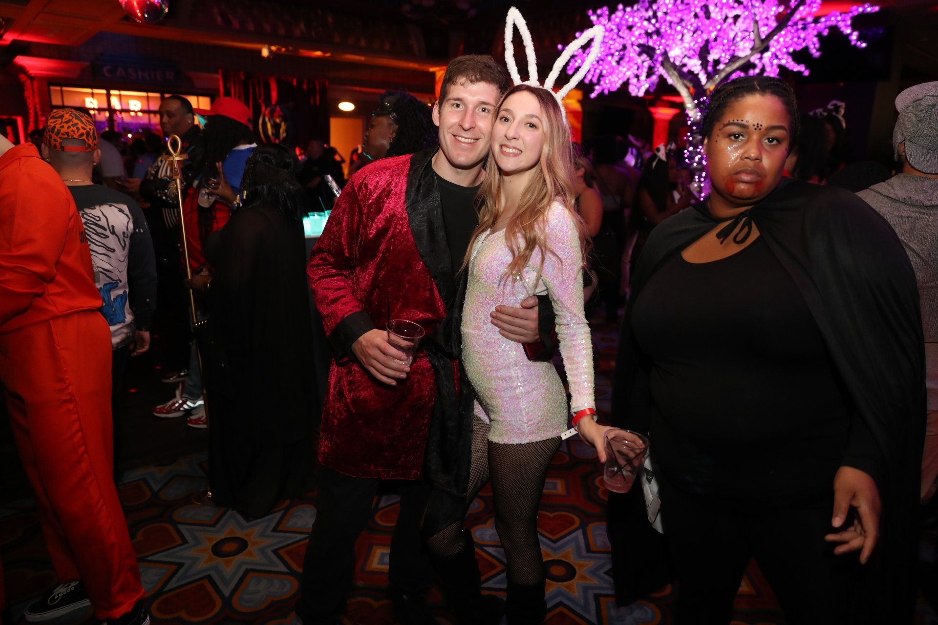 A group of people are posing for a picture at a party.