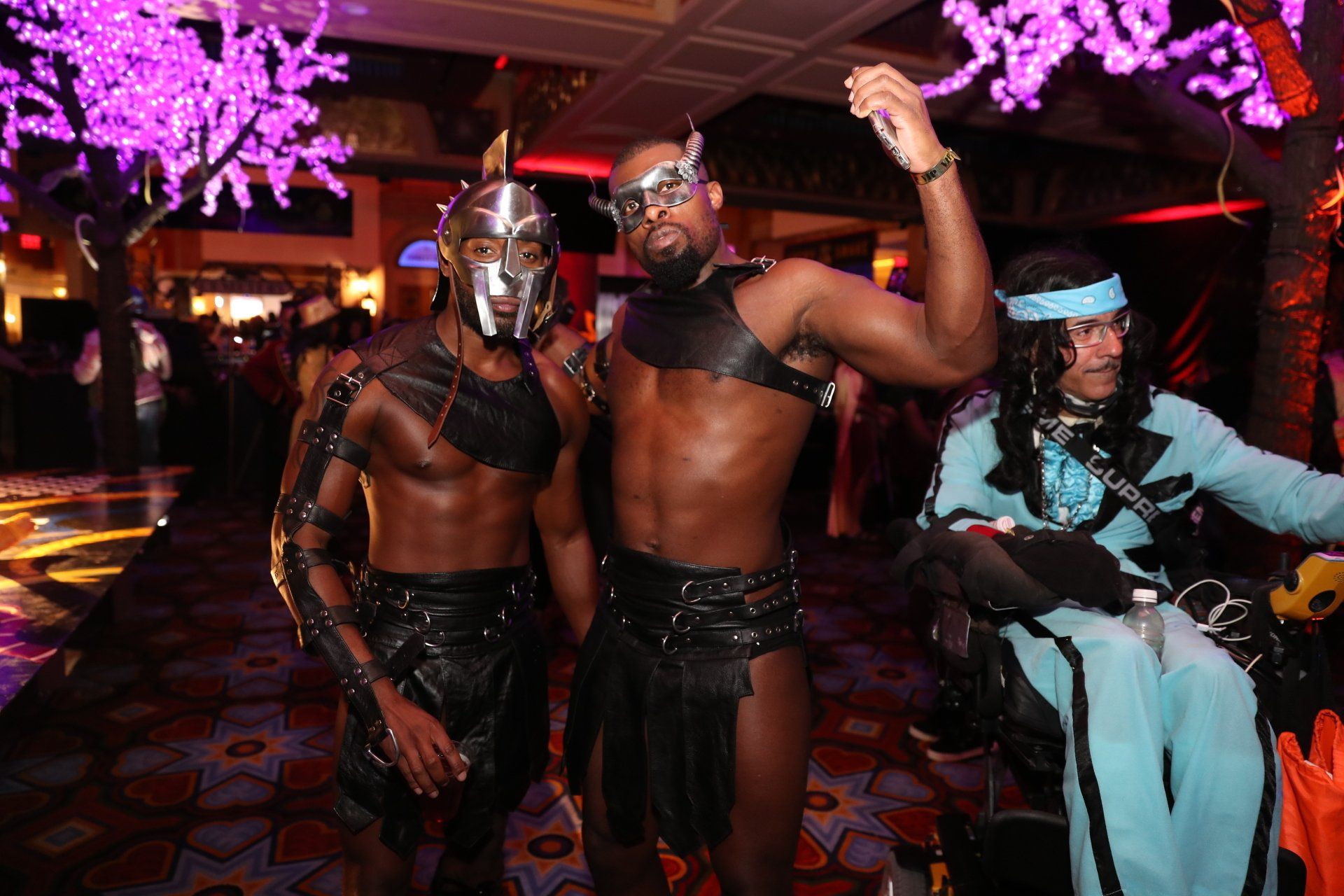 A group of men dressed in costumes are standing next to each other in a room.