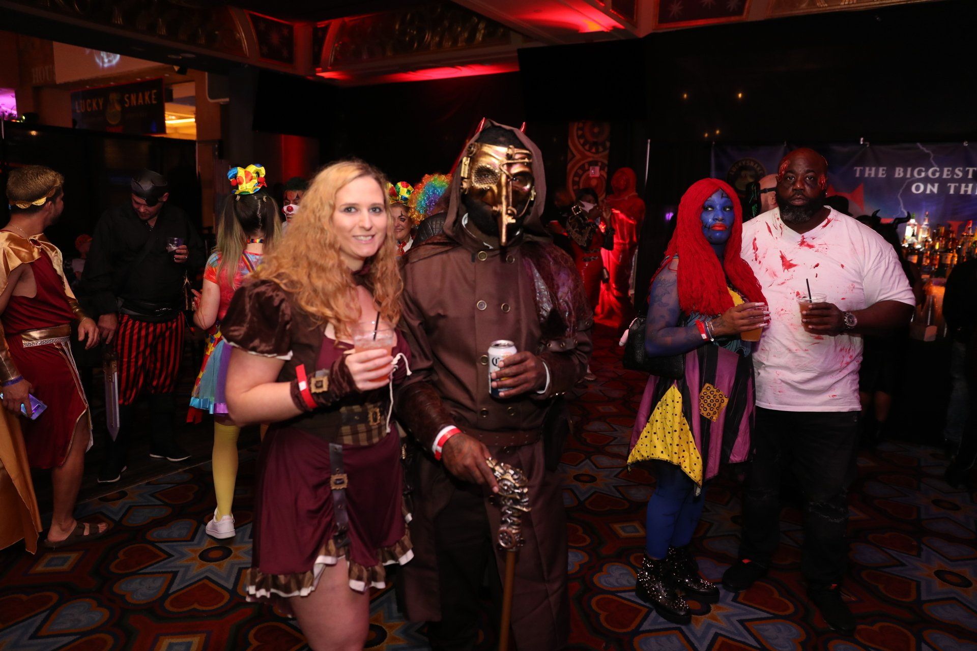 A group of people dressed in costumes are standing in a room.