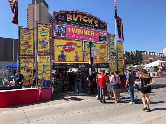 A group of people standing in front of a butch 's winner sign
