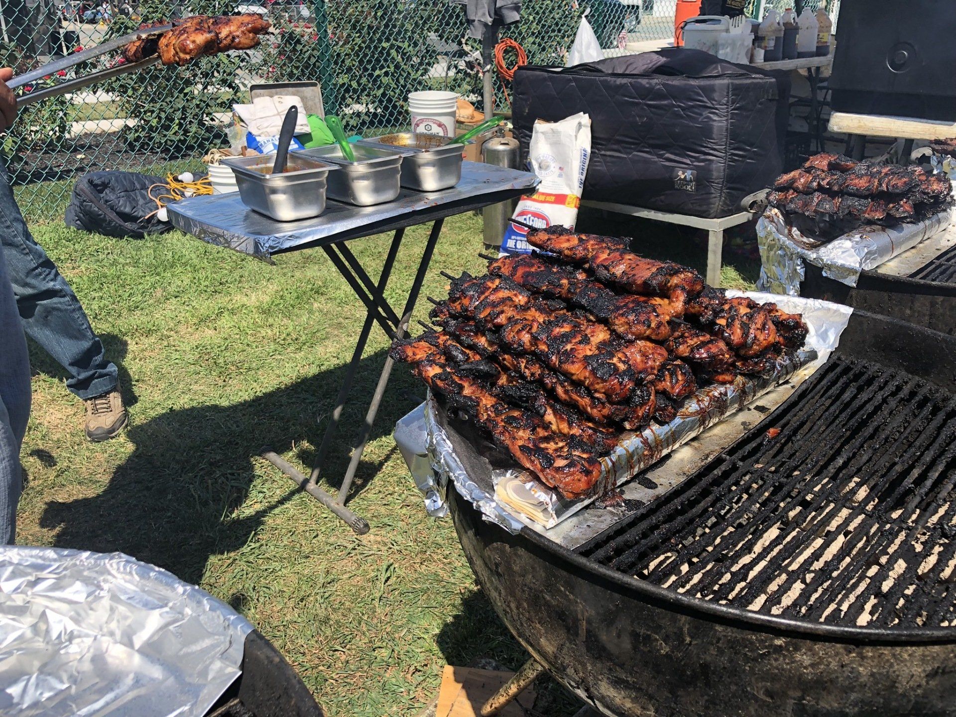 A tray of meat is sitting on top of a grill.