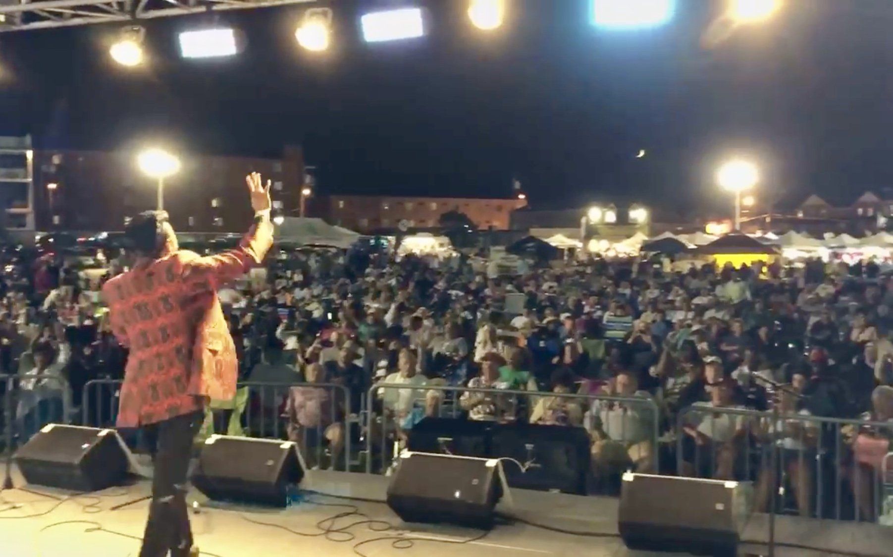 A man is standing on a stage in front of a crowd