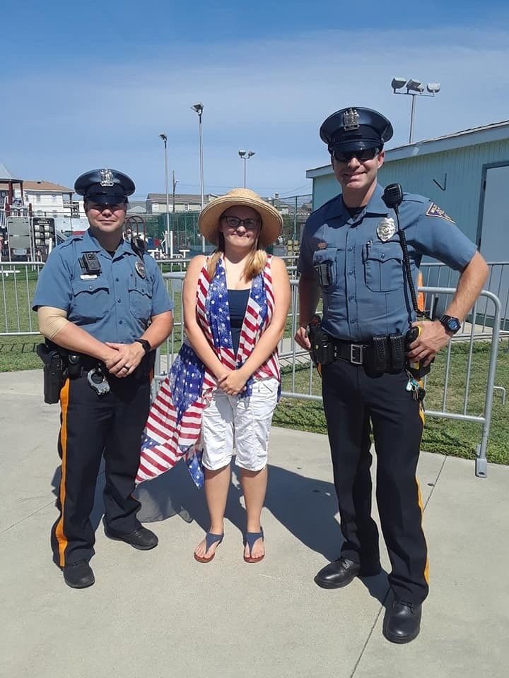 Two police officers and a woman posing for a picture
