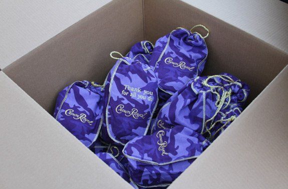 A box filled with purple bags that say thank you