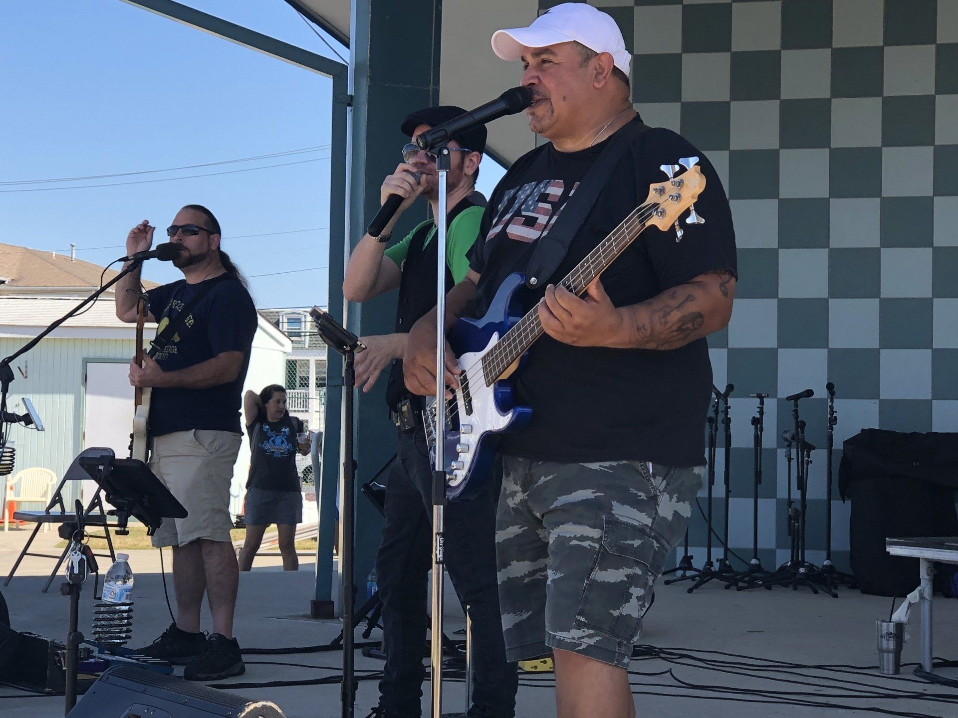 A man singing into a microphone while holding a guitar