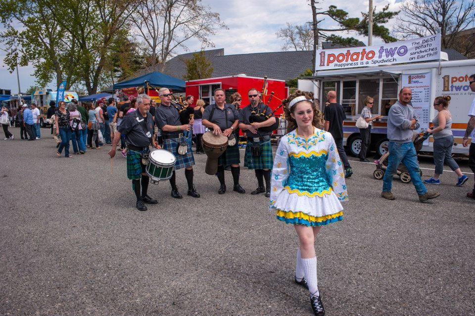 A group of people are marching down a street in a parade.