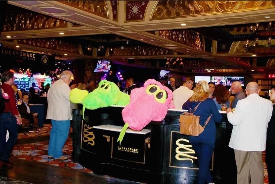 A group of people standing around a table with a sign that says ' a ' on it