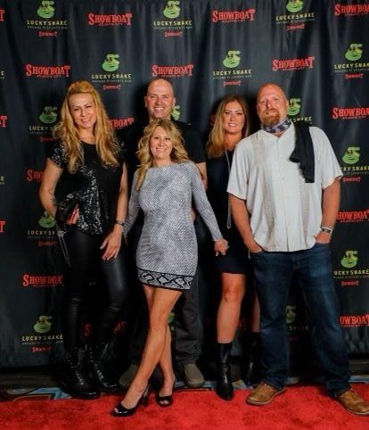A group of people standing in front of a sign that says showboat