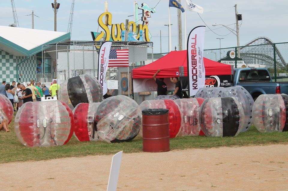 A bunch of bubble balls are lined up in a field