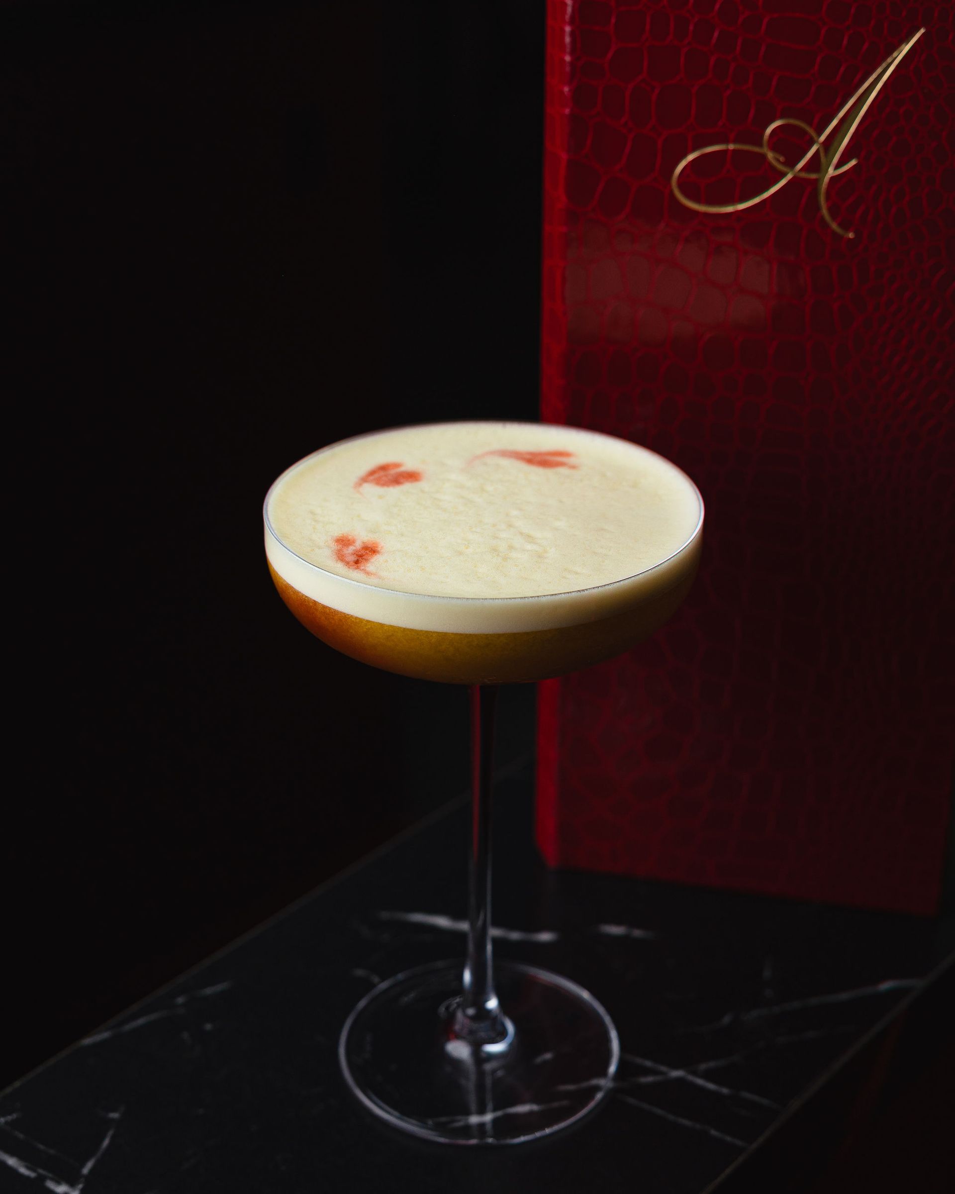 Signature Aura HiFi cocktail served in an upscale lounge setting