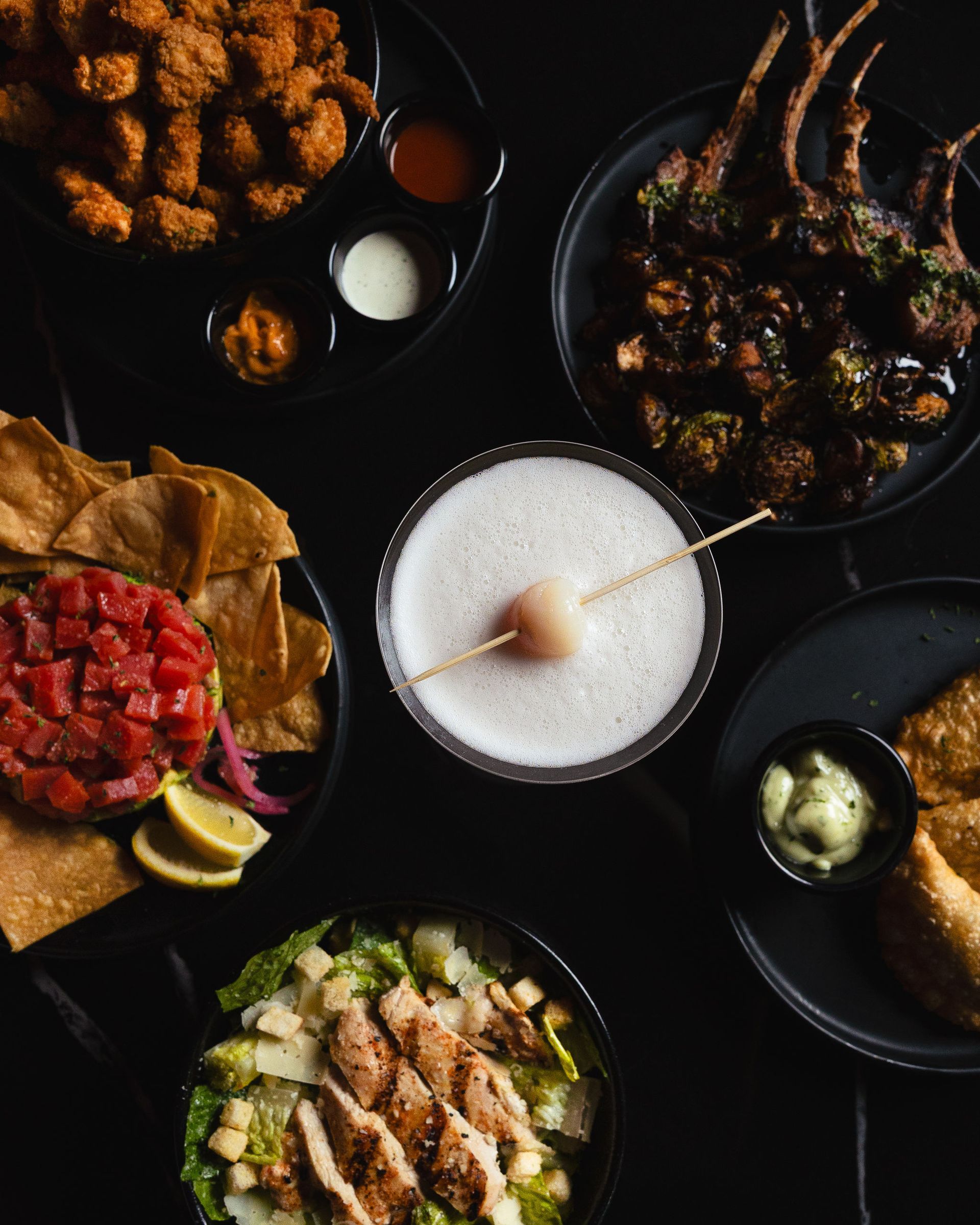 Flat lay of Aura HiFi appetizers cocktails and shared plates