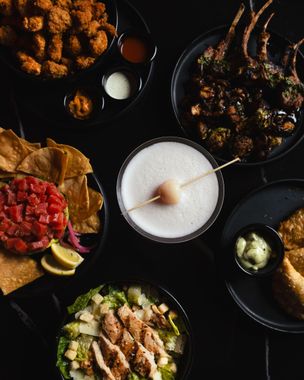 Flat lay of Aura HiFi appetizers cocktails and shared plates