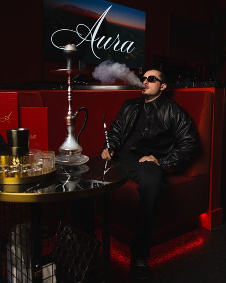 Guest enjoying hookah at Aura HiFi lounge