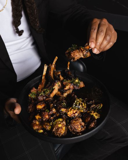 Guest enjoying lamb chops at Aura HiFi fine dining lounge