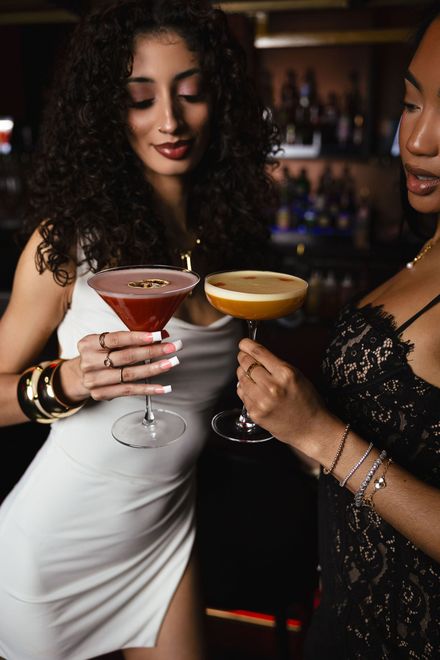 Women toasting cocktails at Aura HiFi lounge in Charlotte