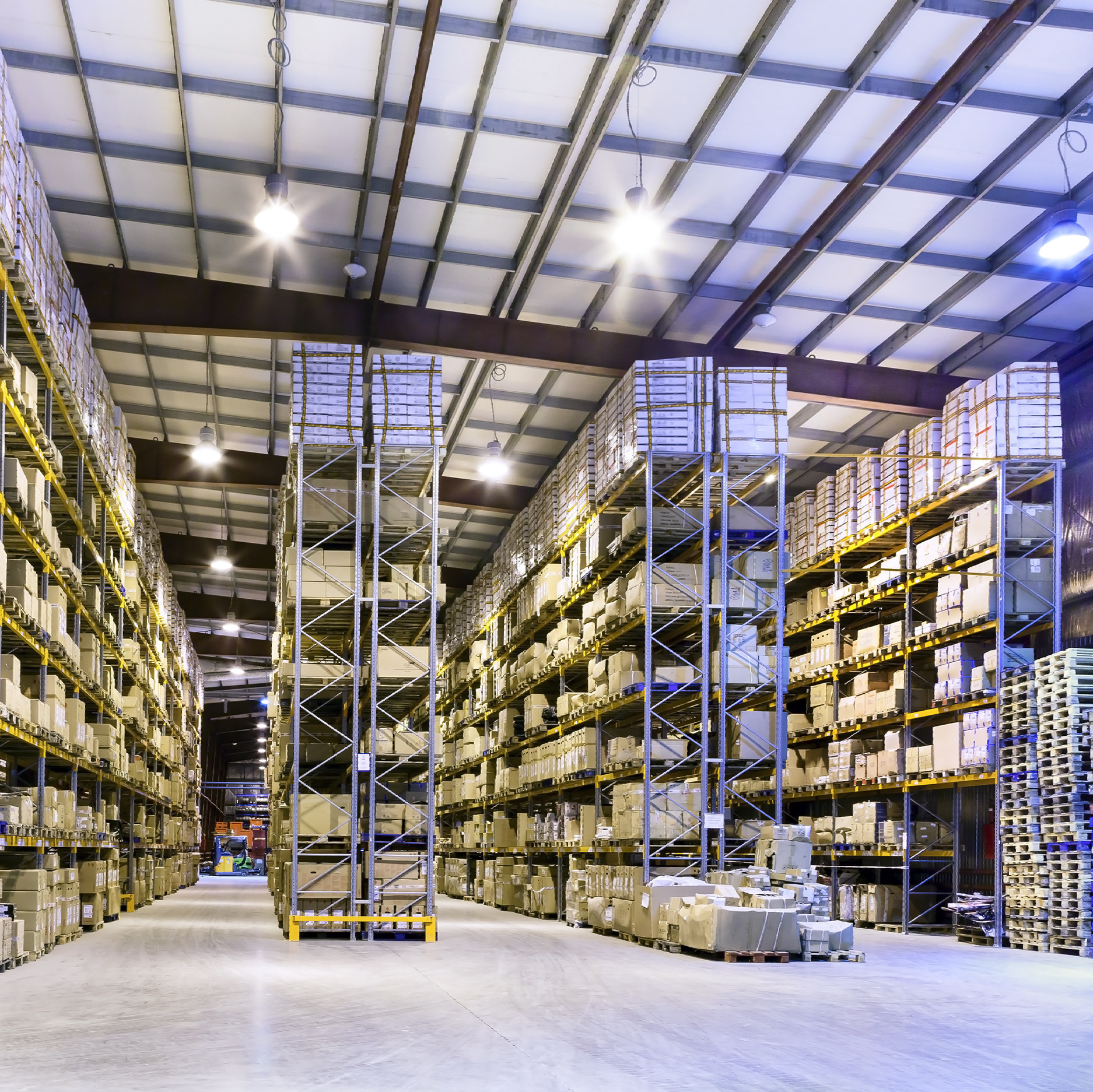 a well-lighted large warehouse filled with lots of shelves and boxes