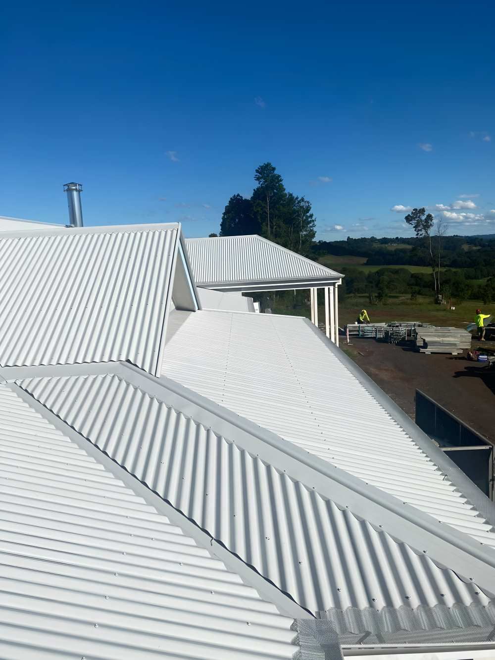 A White Roof With A Blue Sky In The Background — Southern Cross Roof Plumbing in Tregeagle, NSW
