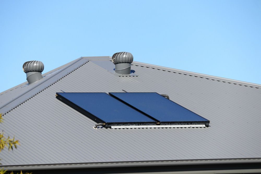 Two Solar Panels Are On The Roof Of A House — Southern Cross Roof Plumbing in Casino, NSW