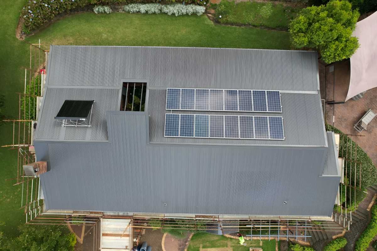 Aerial View Of A House With A Newly Installed Roof With Solar — Southern Cross Roof Plumbing in Mullumbimby, NSW