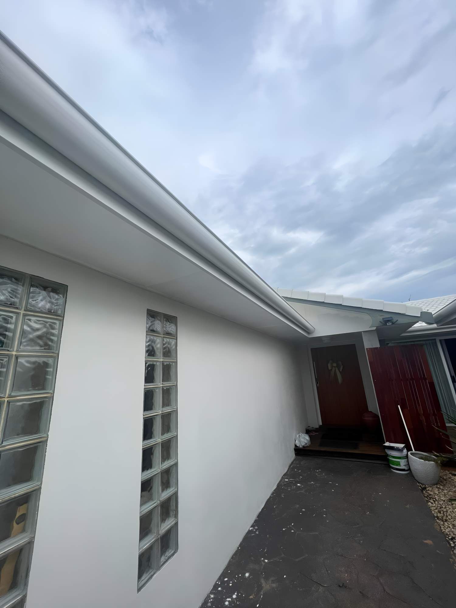 A White House With A Gutter Along Its Side — Southern Cross Roof Plumbing in Mullumbimby, NSW