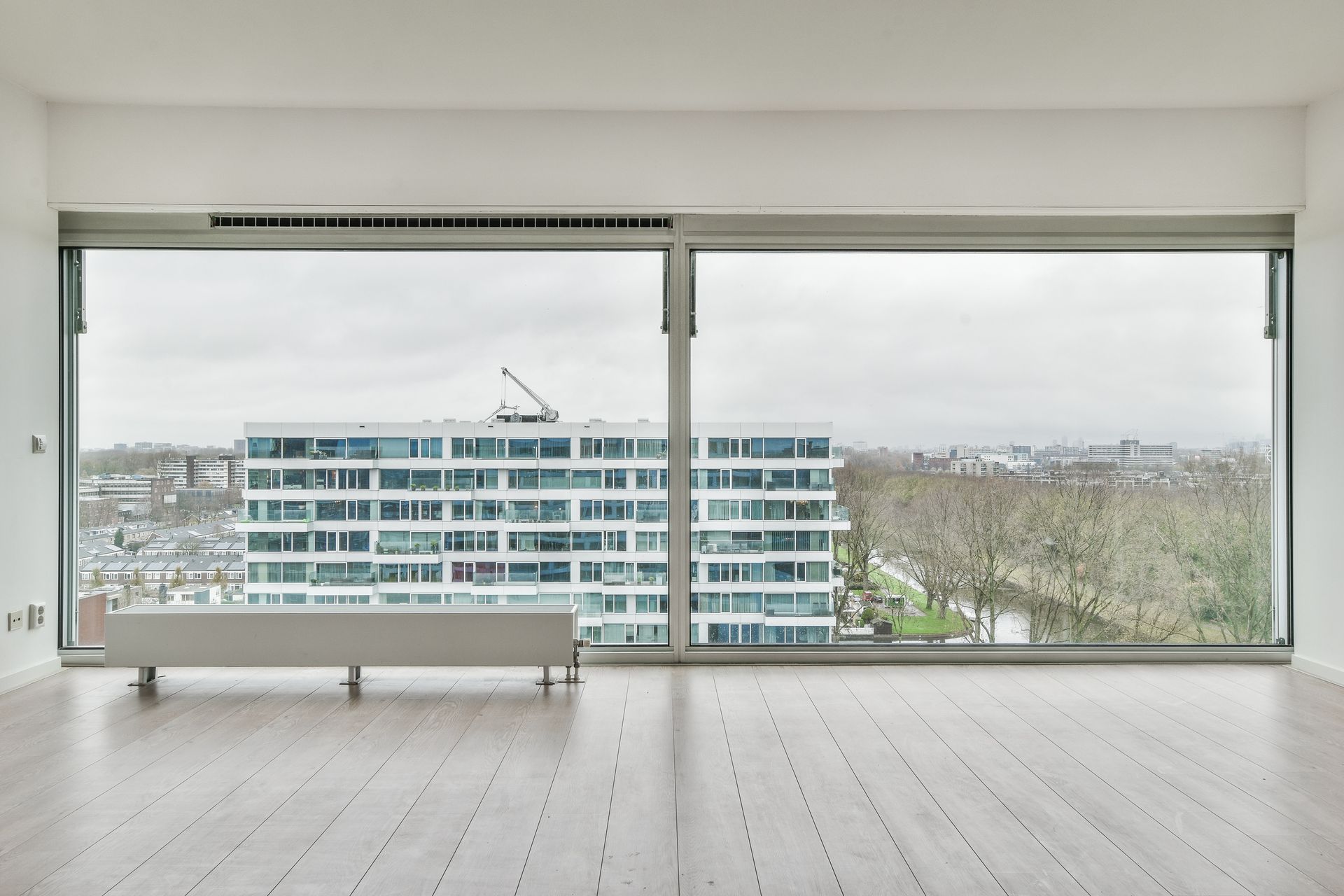 Large windows in a home overlooking a apartment complex