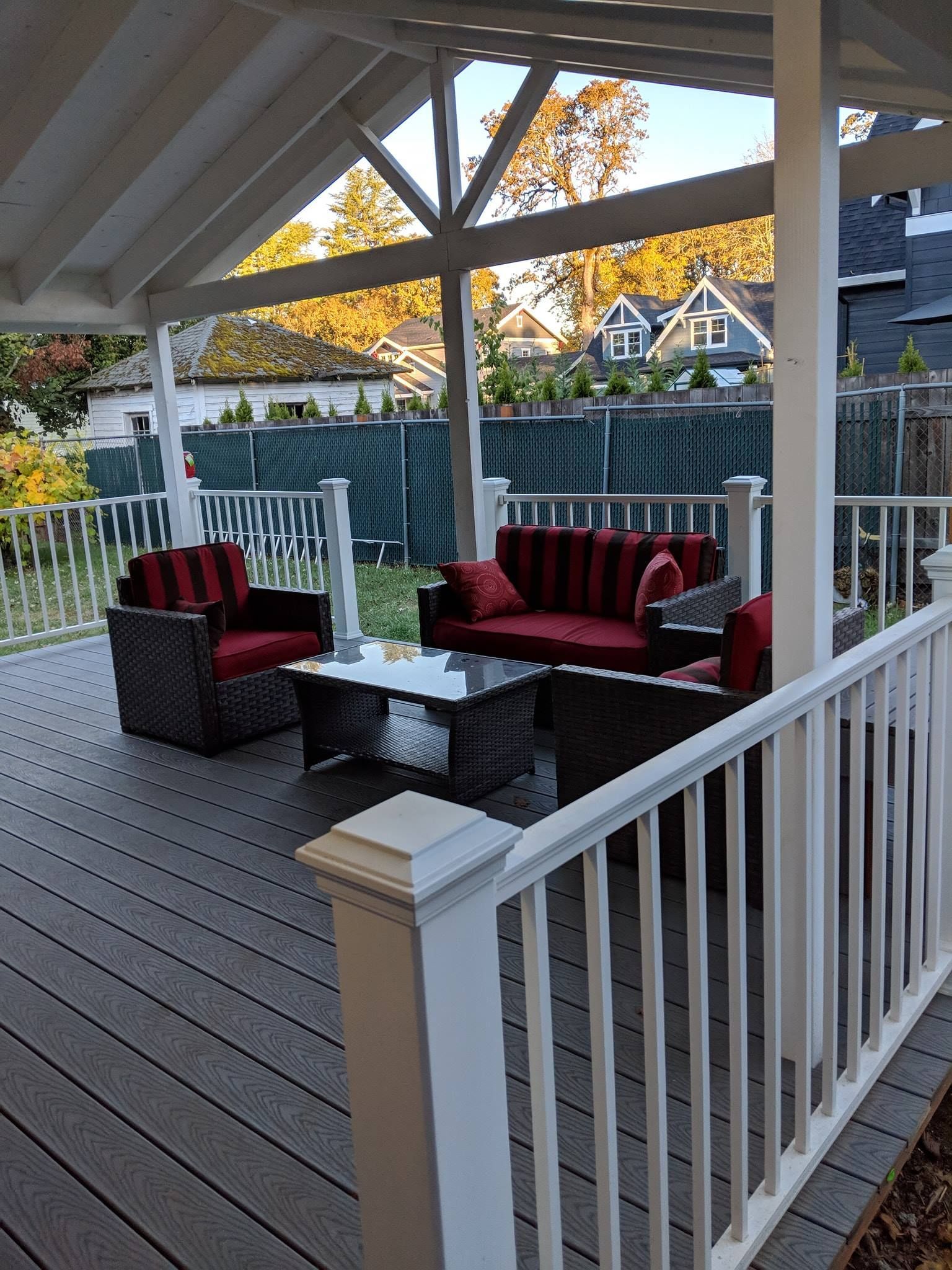 Dark deck enclosed by wooden fence and siding. Speed limit sign visible.