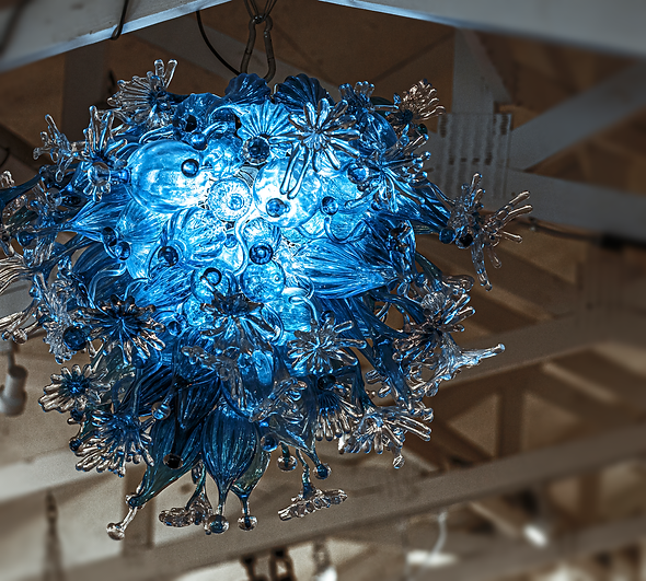 A blue glass chandelier is hanging from the ceiling