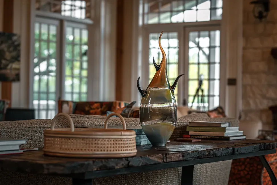 A wicker basket is sitting on top of a wooden table in a living room.