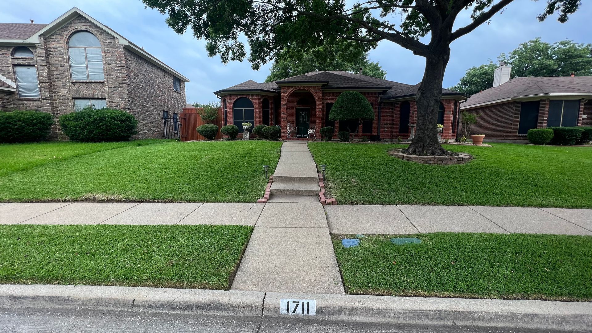 Scenic garden landscape featuring lush green lawns intersected by charming brick pathways, showcasing exquisite garden landscape design.