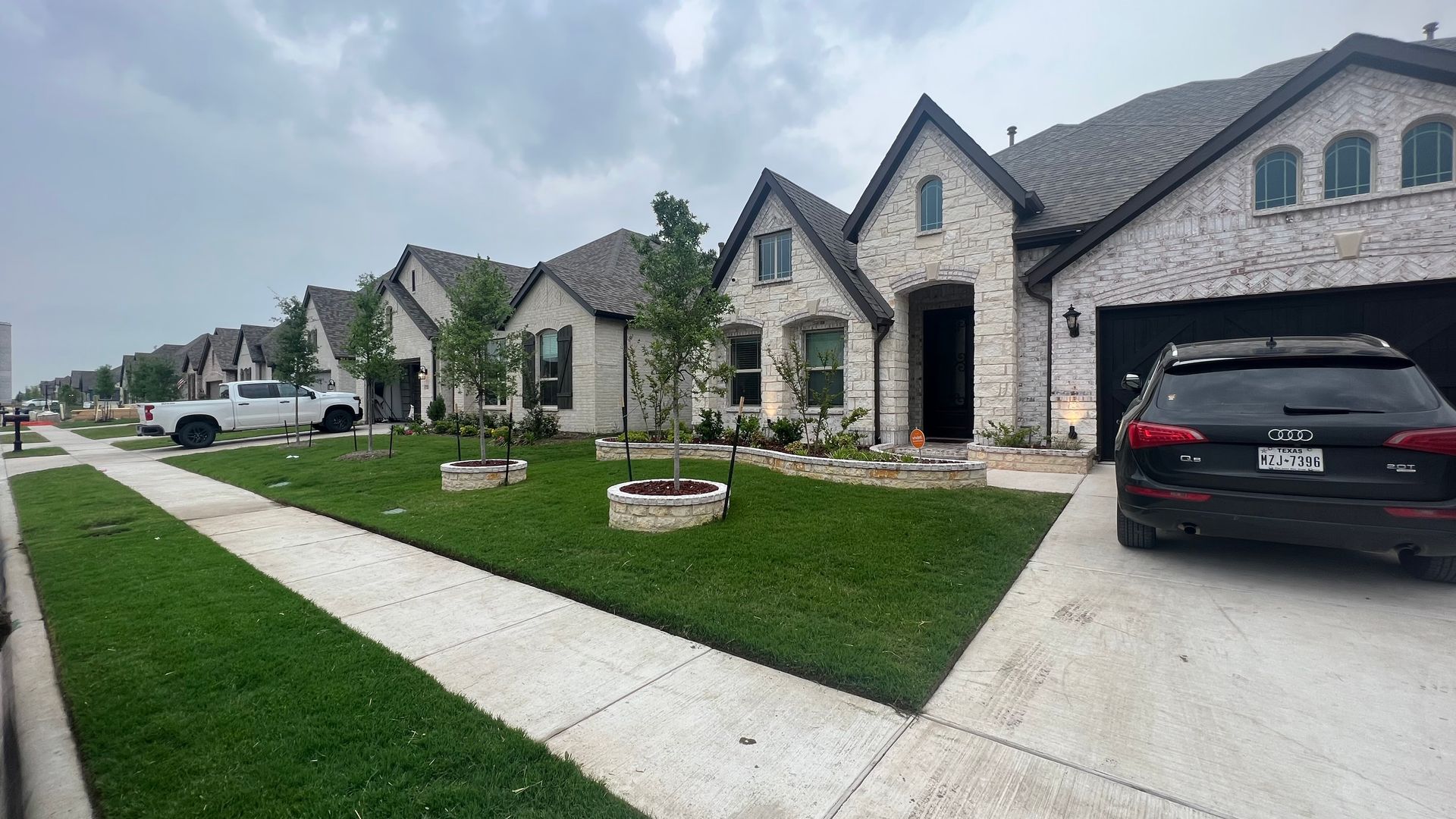 A car is parked in front of a row of houses.