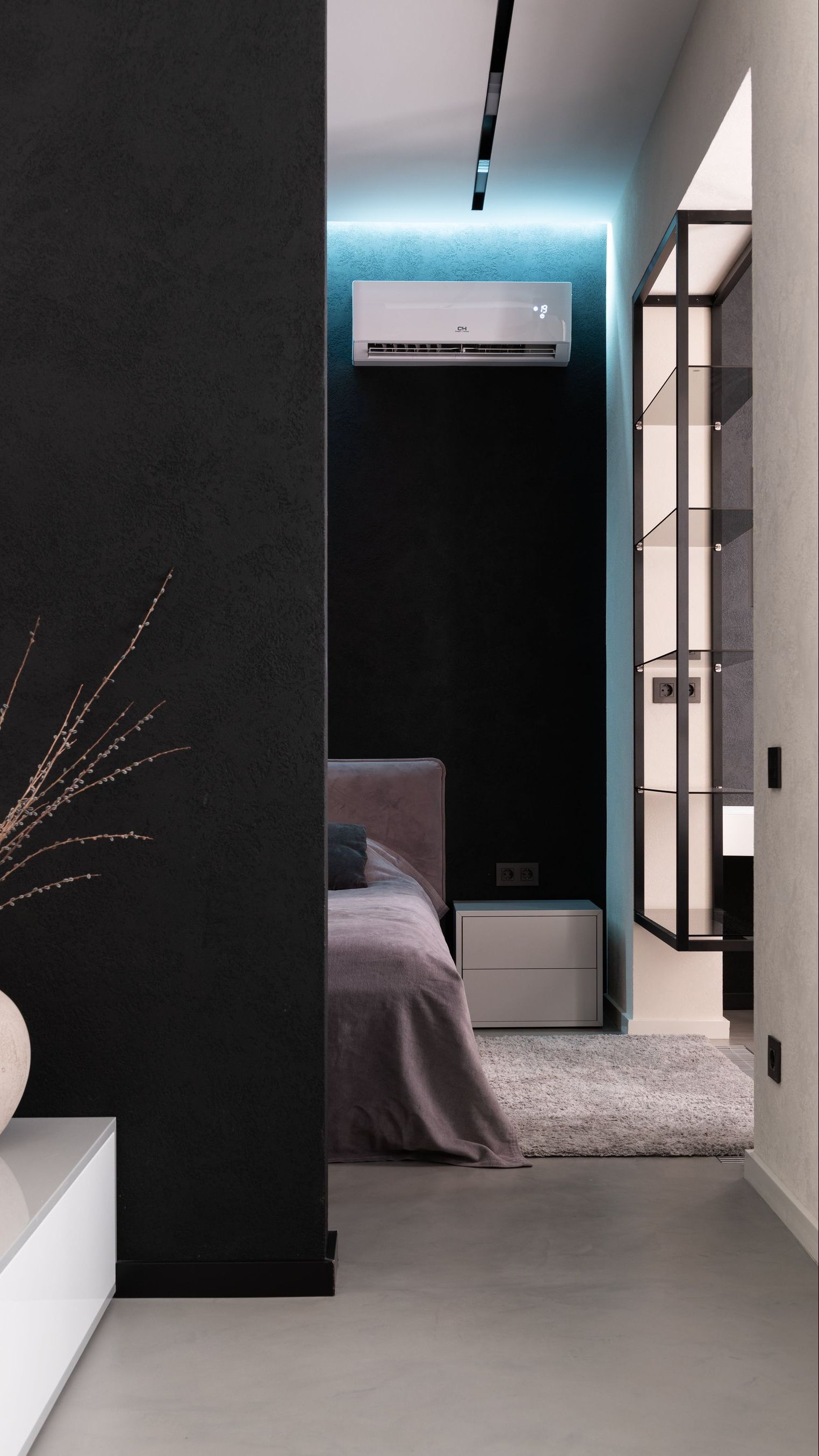 a bedroom with a black wall and a white air conditioner