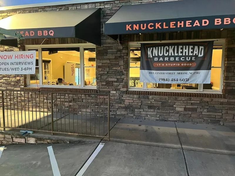 Knucklehead Barbecue storefront with stone exterior, awnings, and a 