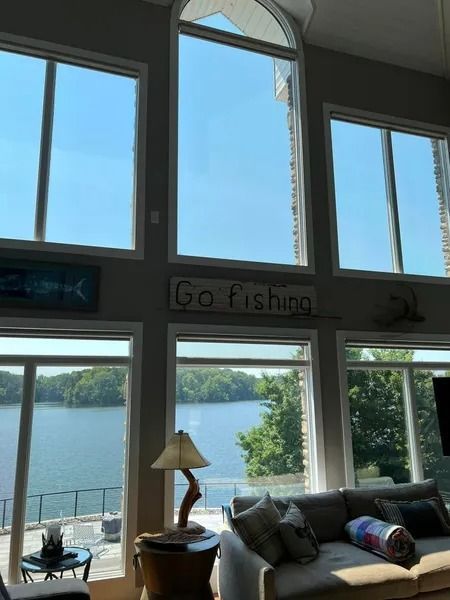 Living room with large windows overlooking a lake, with 