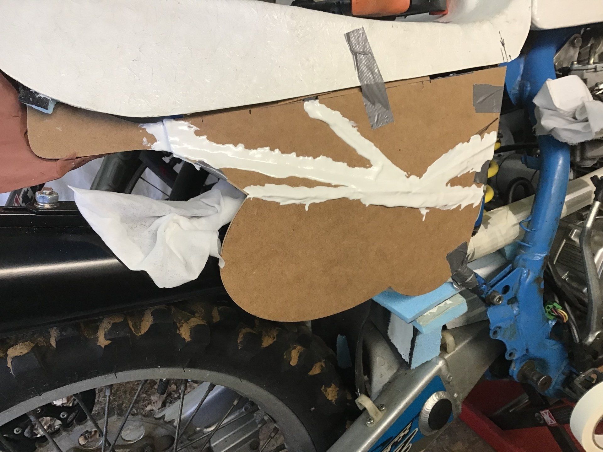 Gluing motorcycle side panel using resin