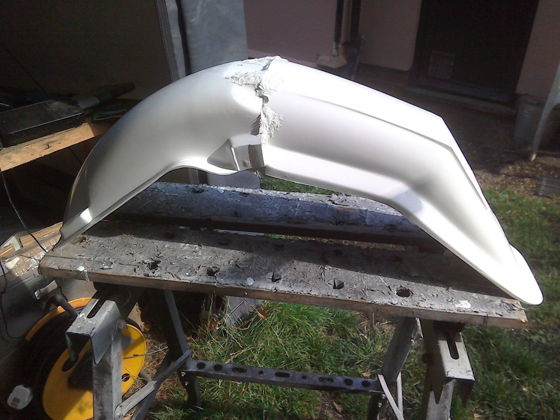 Mudguard halves permanently joined