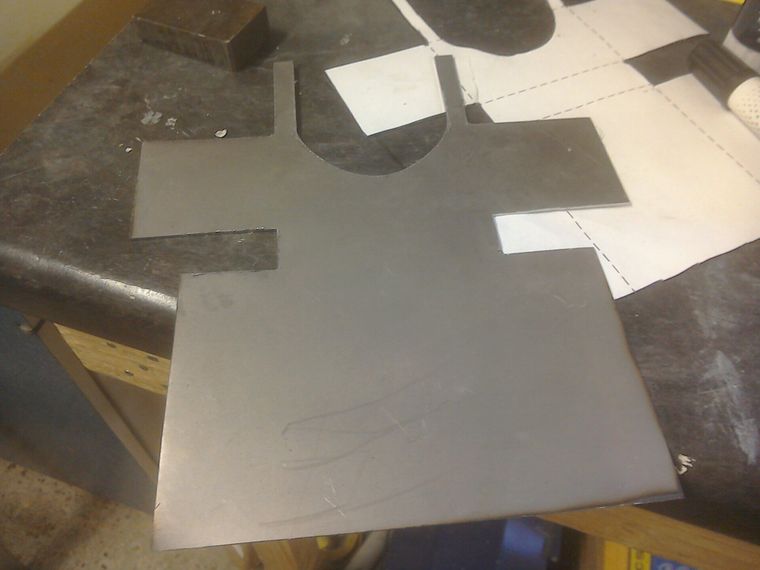 Cutting out sheet steel template for motorcycle petrol tank