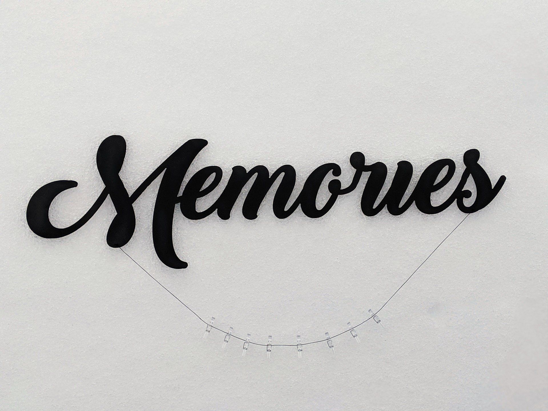 The word memories is written in black on a white background