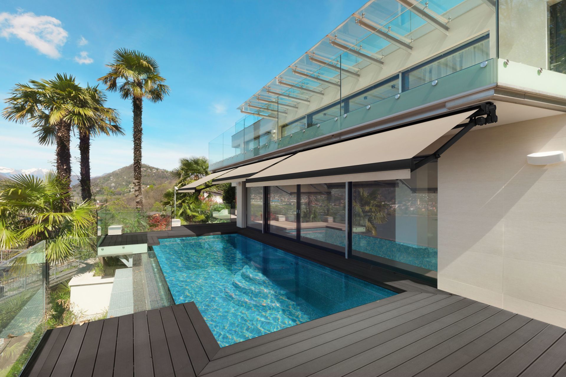 A large house with a swimming pool and a deck.